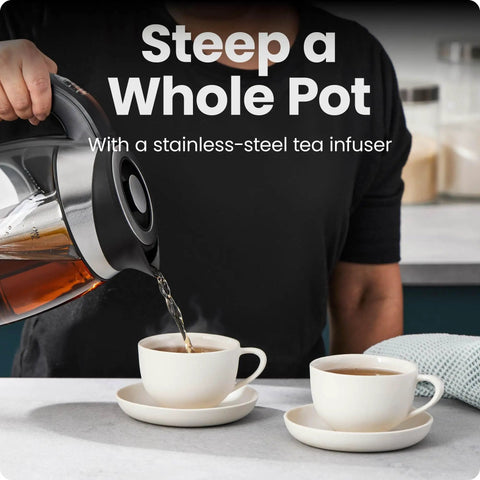 Person pouring tea from Electric Kettle With Temperature Control And Removable Infuser, Glass 1.8L, 5 Presets into cups