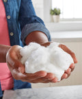 Hands holding crafted slime using Liquid School Glue That Bonds Paper, Wood, Fabric And More, Washable, Safe And Non Toxic.