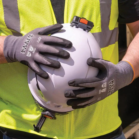 Cut Resistant Work Gloves With Nitrile Coated Grip, HPPE Fabric For Flexibility And Dexterity, Touchscreen Compatible, ANSI A4, XL Size, 2 Pack For Pro Level Handling And All Day Comfort being worn while holding a hard hat.