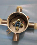 Front view of round stainless steel explosion-proof junction box with four conduit ports and blue terminal plate.