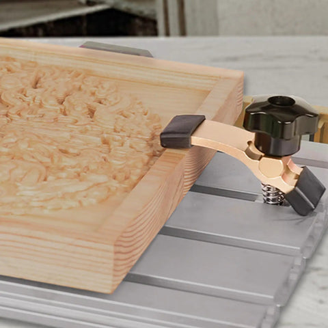 Close-up of Commercial Grade Aluminum Router Clamping Kit with T slot guides securing wooden stock on CNC milling surface.