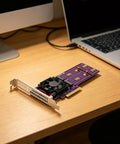 Kickstart Desktop Upgrade With This Dual Bay M.2 NVMe Enclosure Feature PCI Express 4.0 Riser Card on a wooden desk.