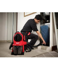 Worker using M18 FUEL 3-In-1 Backpack Vacuum for jobsite cleanups with Powerstate brushless motor, wearing vacuum