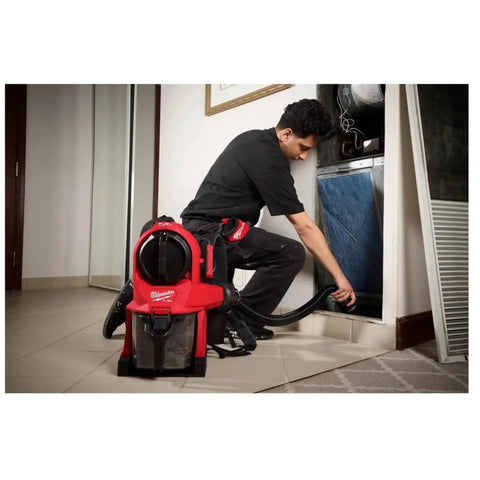 Worker using M18 FUEL 3-In-1 Backpack Vacuum for jobsite cleanups with Powerstate brushless motor, wearing vacuum