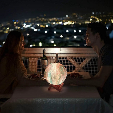 Couple dining with 7.0 Inch Moon Lamp Night Light With 16 Color LED, 3D Printed Moon Surface on table, night city view