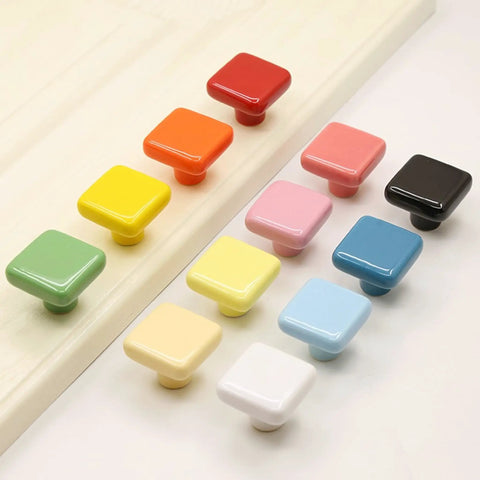 Colorful variety of ceramic square knobs in 1.25 inch size, showcasing vibrant design options for kitchen and dresser cabinets.