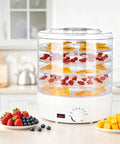 Heavy Duty Electric Food Dehydrator With Five Clear Trays And Adjustable Heat Zones For Zero Fuss Drying Of Fruit Meat Jerky And Custom Pet Treats Perfect For Family Dinners And Weekend Meal Prep, displaying fruits on trays.