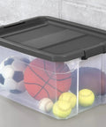2 Pack 76 Quart Clear Stackable Storage Bins With No Fuss Latch Lids And Dark Gray Covers showing sports balls inside for organization.