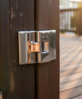 316 Stainless Steel Heavy Duty Hinge With Broad Mounting Plates Polished Finish For Sunroom Roofs Rv Campers Marine Builds Home Reno installed on wooden post.