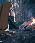 Beefy Heavy Duty Survival Blanket With Reflective Tarp For Camping And Outdoors by a campfire, showcasing thermal use