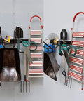 Heavy Duty Steel Garage Wall Mount Tool Organizer with 8 Mixed Hooks, holding ladder, tools, wheelbarrow against a garage wall