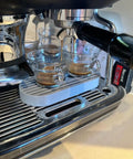 Level Up Your Counter Game With This Heavy Duty Cup Riser Platform designed to elevate espresso mugs by thirty millimeters on a drip pan.