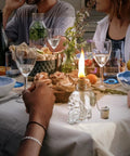 Lit Skeleton Skull Glass Table Torch For Outdoor Patio Decor on dining table with vibrant food and drink setup