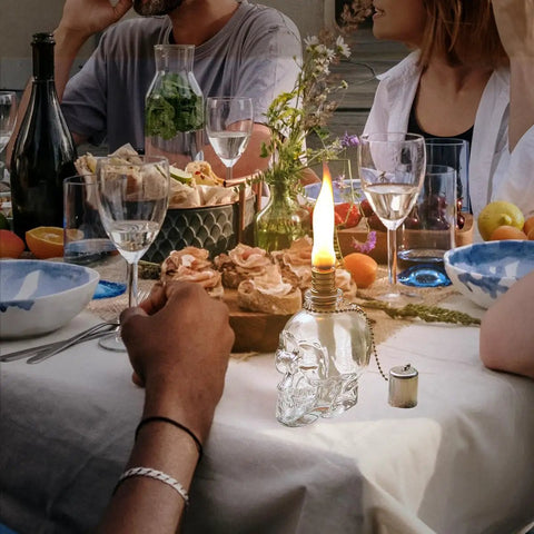 Lit Skeleton Skull Glass Table Torch For Outdoor Patio Decor on dining table with vibrant food and drink setup
