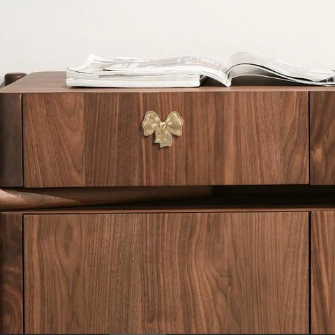 Luxurious Vintage Brass Bow Drawer Handles For Furniture And Boxes. Small gold bowknot pull on walnut wood cabinet front.