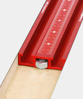Close-up of the red 36 inch fence with measuring scale for Knockout Rock Solid Micro Dot Drill Press Table Kit.