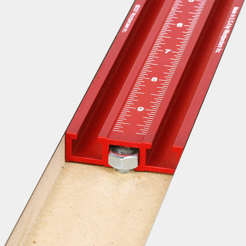 Close-up of the red 36 inch fence with measuring scale for Knockout Rock Solid Micro Dot Drill Press Table Kit.