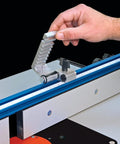 Rock Solid Precision Router Table Stop With Dead Nuts Accurate Lens Cursor And Swift Swing Away Fence Lock positioned on blue rail.