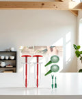 Six Piece Mini Seed Spreader Set For Tiny Seeds, Handheld Seed Dispenser, Dibber And Widger Tools on a white surface indoors
