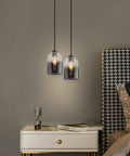 Two black glass cylinder pendant lights set of 2 - modern farmhouse style double glass gradient shades for bedroom nightstand.