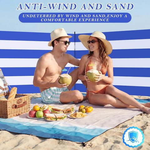 Couple enjoying beach picnic with Long Beach Wind Screen 25 Ft By 4 Ft Privacy Fence With 5 Foldable Metal Poles For Sand Protection