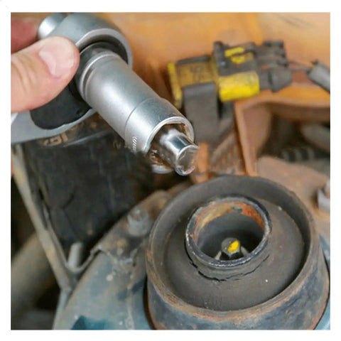 Close-up of 18 Piece Hub Suspension Nut Removal Tool Socket Kit For Shock Absorber Struts being used on car suspension.