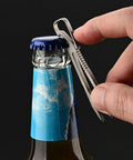 Alloy Pocket Tweezers For Camping And Hiking Gear, compact tool used as bottle opener, close-up on blue-capped bottle and hand