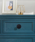 Close-up of Top Shelf Matte Black Six Pack Round Cabinet Knobs For Kitchen Cupboards on a blue dresser.