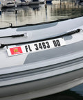 Marine Registration Plate Kit For Inflatable Boats And Ribs No Glue Needed 4 By 24 Inch ABS Mounting Boards With Zip Ties Saltwater Resistant Made In USA Pair displayed on an inflatable boat