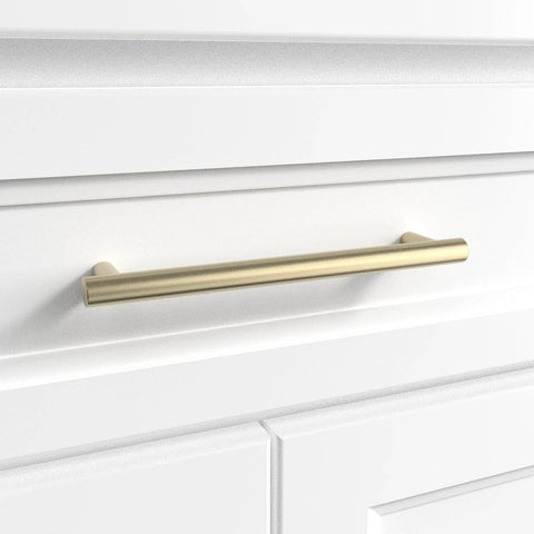 Door And Drawer Pulls 6-Inch Center-To-Center Brushed Titanium Gold Finish 10 Pack for cabinets and furniture upgrades on a white drawer.