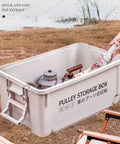 Heavy Duty Rolling Bin With Secure Lid And Easy Roll Casters, stackable outdoor storage box holding gear by the water.