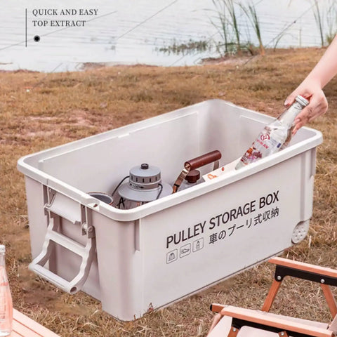Heavy Duty Rolling Bin With Secure Lid And Easy Roll Casters, stackable outdoor storage box holding gear by the water.