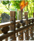 Outdoor Torch Holder Clamp For Deck And Garden String Light Poles Tiki Torch Mount installed on wooden railing