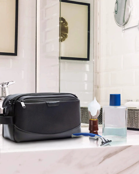 Men Toiletry Bag Large Travel Organizer Dopp Kit Water Resistant PU Leather Exterior With Wide Opening Interior Compartments In Black on bathroom counter