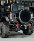 Rear view of a 1/18 TRX4M Bronco with aluminum rear bumper, removable tow hitch, fitting stock body, no mods required.