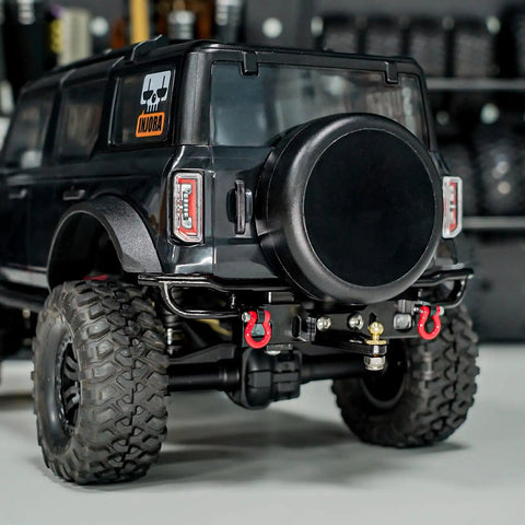 Rear view of a 1/18 TRX4M Bronco with aluminum rear bumper, removable tow hitch, fitting stock body, no mods required.