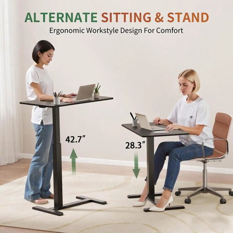 Two women using the Mobile Standing Desk With Wheels Height Adjustable Pneumatic Laptop Desk Overbed Table, 28.3" to 42.7" height