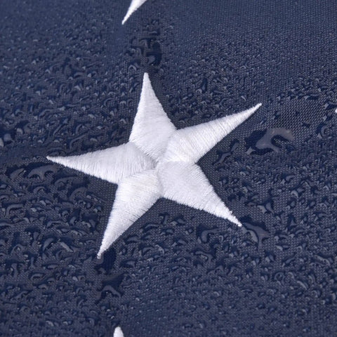 Close-up of embroidered star on 5x8 Ft US Flag For Outdoor Use High Wind With Embroidered Stars And Sewn Stripes Brass Grommets Built To Last In Any Weather UV Protected Water Resistant Weatherproof Durable Outdoor Flag