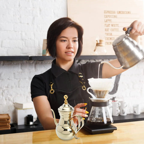 Barista using Stainless Steel Arabic Coffee Pot And Pour Over Teapot Set With Infuser Multiuse Coffee Kettle in cafe.