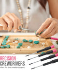 11 Piece Pink Womens Compact Crafts And Home DIY Tool Kit Set With Pliers Cutters And Precision Screwdrivers For Ladies Ideal For Quick Home Repairs And Craft Projects, focus on precision screwdrivers next to hands using a tool on gemstones.