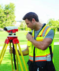 Mens Premium Surveyor Vest Class 2 Hi Vis Safety Vest Ten Roomy Pockets Heavy Duty Zip Rock Solid High Visibility Workwear Built Tough For The Daily Grind Large Lime And Black on a worker using surveying equipment.