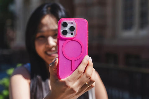Milan Snap Case For IPhone 16 Pro Max Pink Glitter MagSafe Compatible Case held up outdoors showing sleek design
