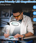 Man using 10X Lighted Magnifying Glass With Adjustable Swing Arm And 72 LEDs Real Glass Lens Loupe for detailed workbench tasks