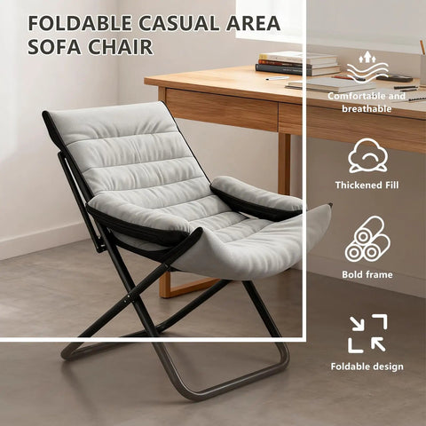 Gray folding casual area sofa chair with thick fill and bold frame, displayed near a wooden desk.