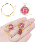Hand holding Rose Red Enamel Alphabet Charms And Golden Wine Glass Marker Rings Set Including 52 Alphabet Charms And 60 Marker Rings For Wine Tasting Parties Party Favors Gift Decor And Beading Hoops For Diy Jewelry Or Crafts, showing letters M, T, and A with size chart.