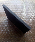Side view of Beefy High Temp Graphite Plate For Pyrolysis Block And Anode, anti-corrosion heat sink, 100x100x35mm, on bubble wrap