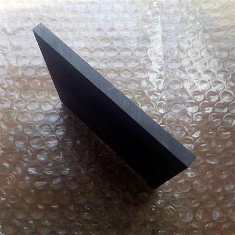 Side view of Beefy High Temp Graphite Plate For Pyrolysis Block And Anode, anti-corrosion heat sink, 100x100x35mm, on bubble wrap