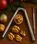Beefy All Metal Nutcracker Tool For Cracking Nuts Lobster Claws Crabs And Tough Shells with walnuts on wooden surface