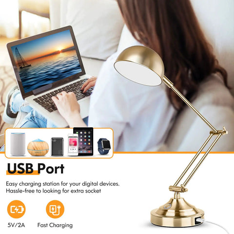 Brass Vintage Desk Lamp with USB Port next to a person using a laptop, illustrating fast charging feature and adjustable arm.