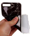 Hand holding black marble-style flexible phone case